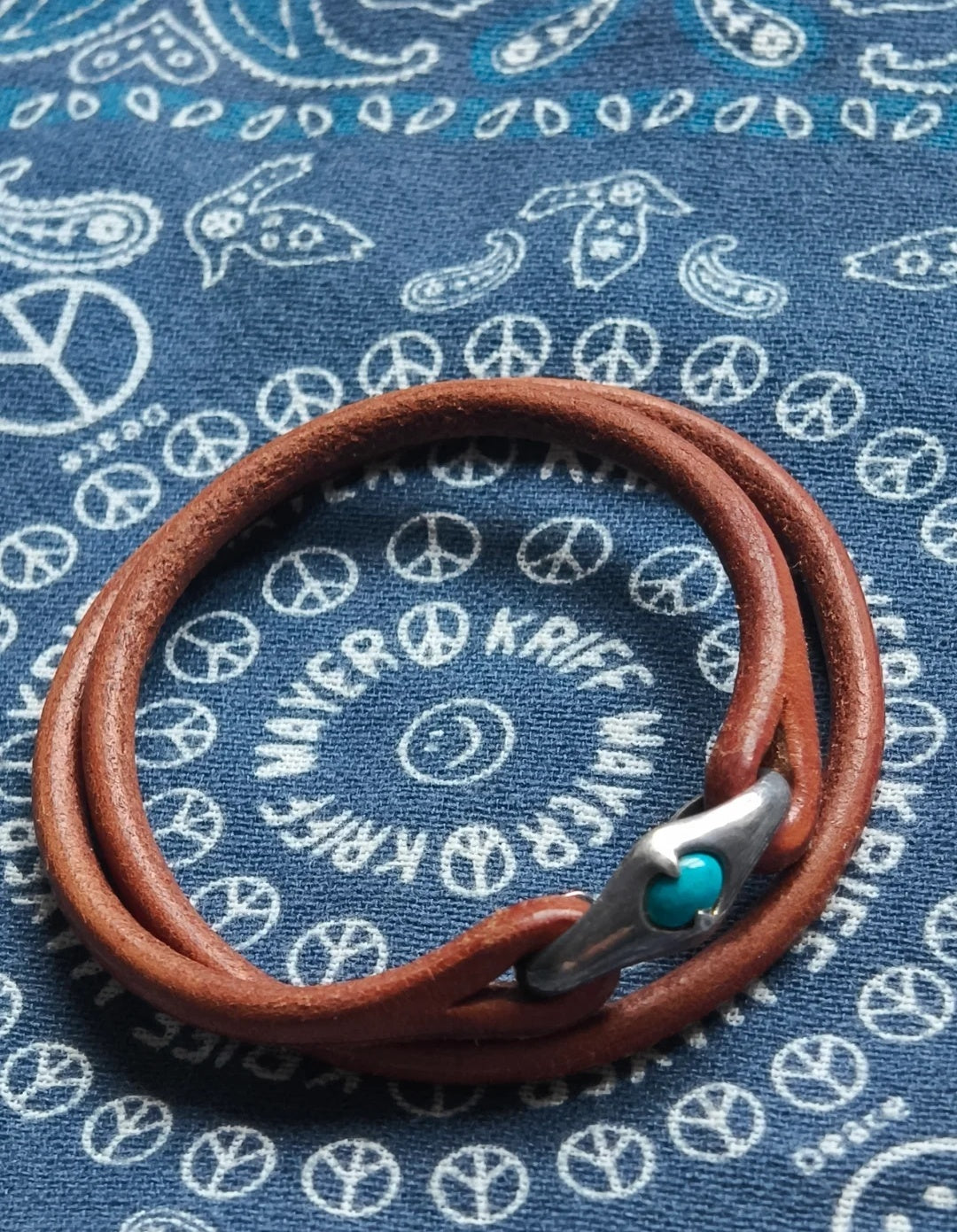 Leather rope bracelet paired with turquoise bracelet and silver jewelry