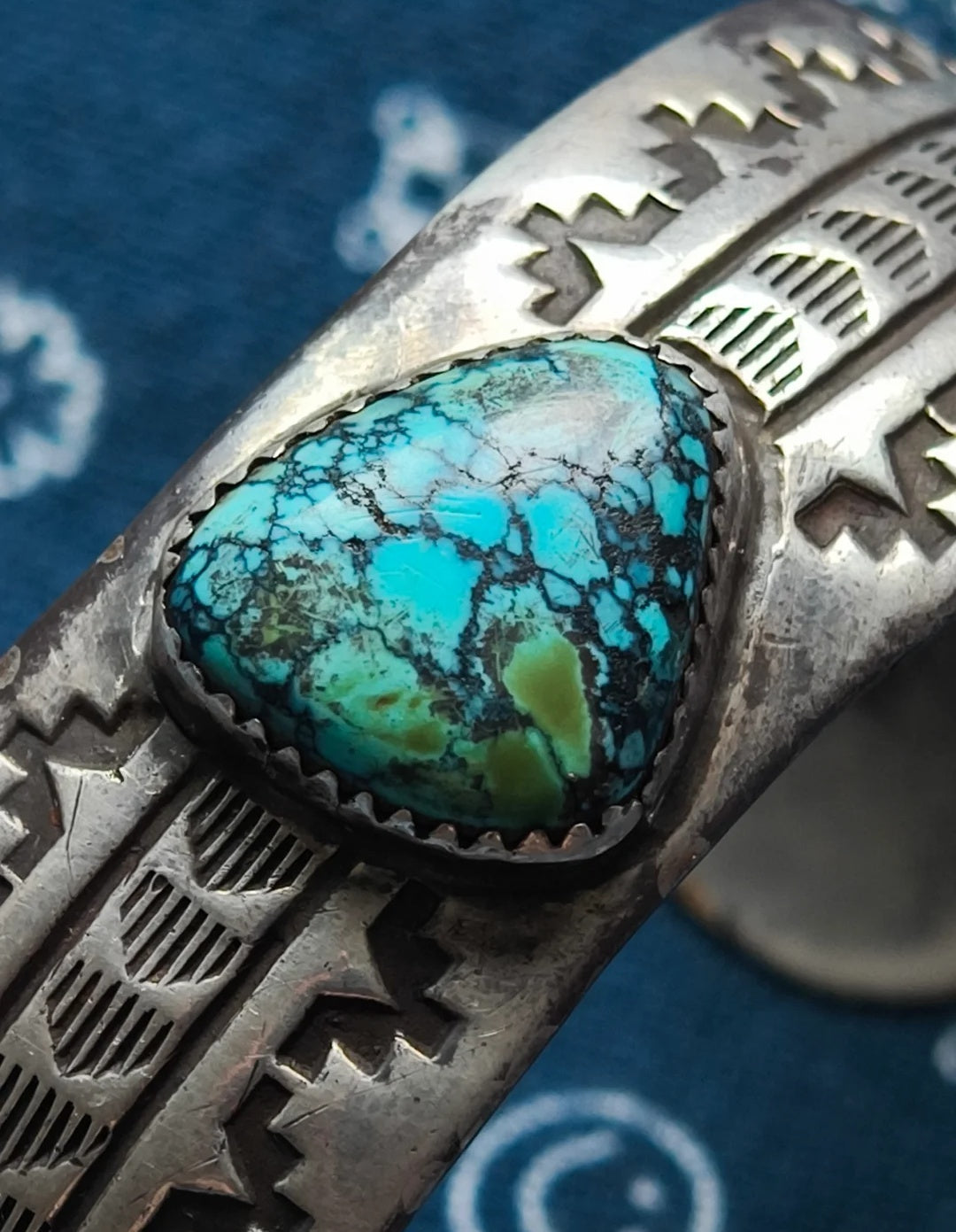 The simple turquoise ring with smooth lines and mysterious Indian totems gives a sense of antiquity and depth, full of a sense of story and the otherworldly charm of turquoise